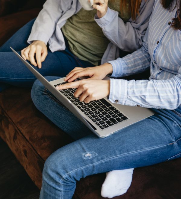 crop-women-using-laptop-sofa-tall.jpg